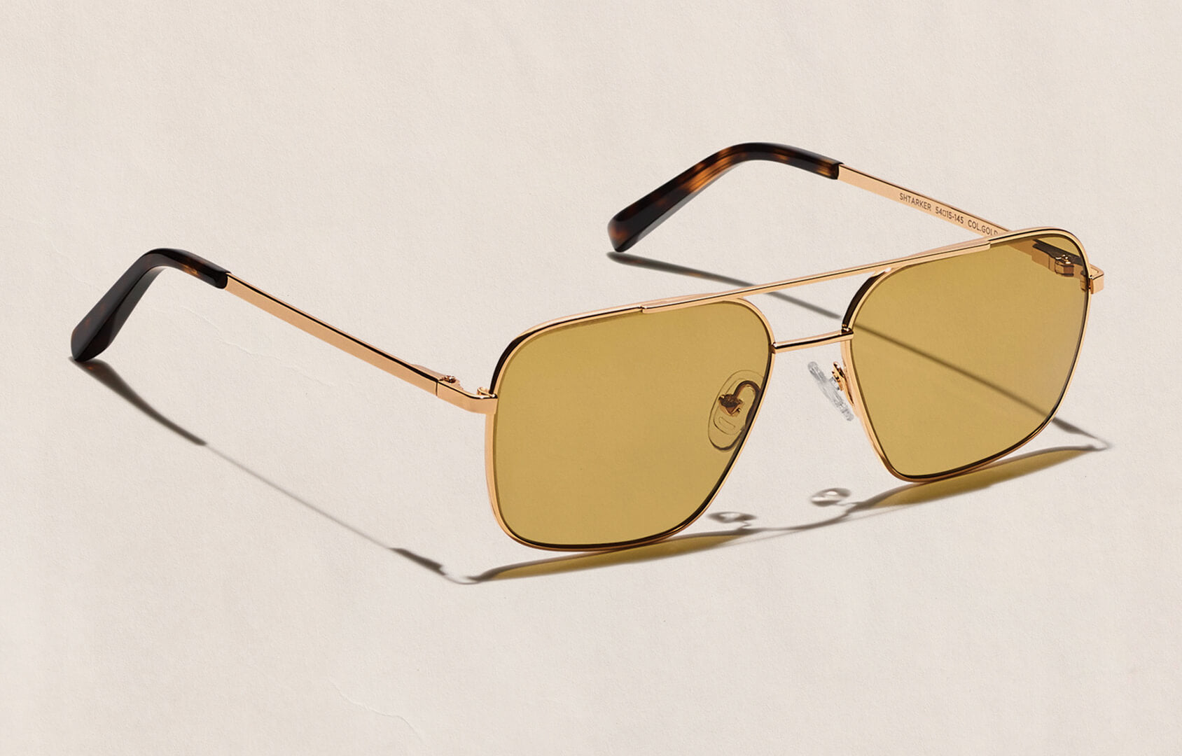 Britt Lower wears The SHTARKER in Gold with Amber Tinted Lenses