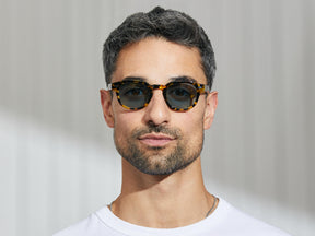 Model is wearing The LEMTOSH SUN in Tokyo Tortoise in size 46 with Mineral Blue Glass Lenses