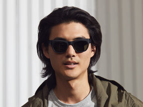 Model is wearing The PUSHKIN in Matte Black in size 51 with G-15 Glass Lenses