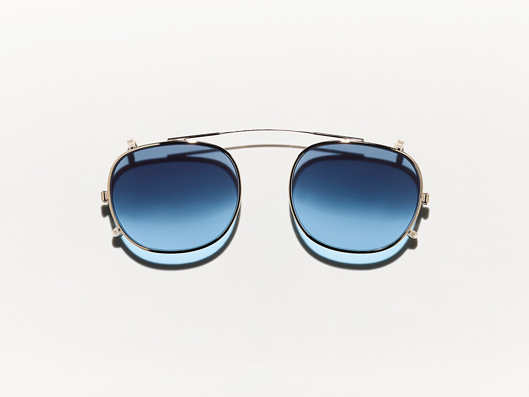 The CLIPTOSH in Gold with Denim Blue Tinted Lenses