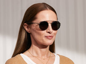 Model is wearing The ZEV CLIP in Matte Black in size 49 with G-15 Glass Lenses