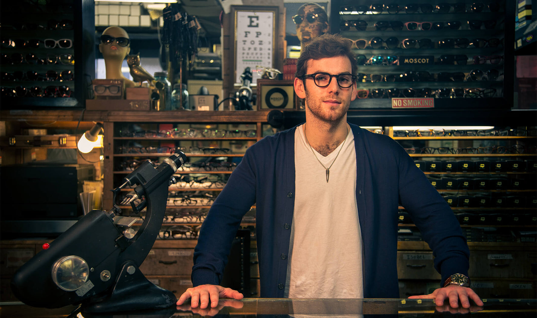 Man behind counter at Moscot store
