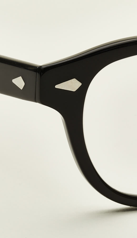 A metal rivet on a glasses frame