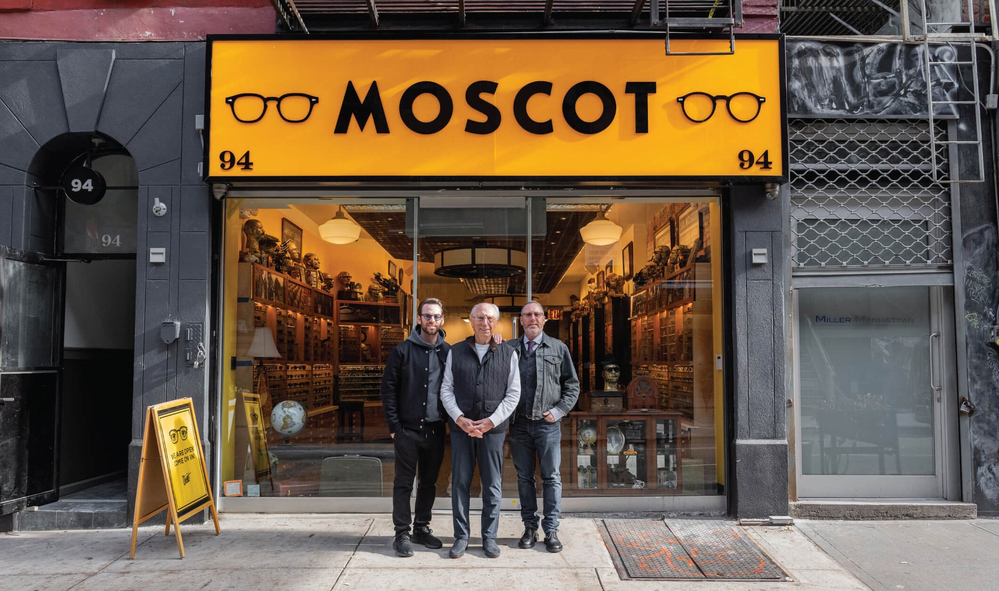Three generations of Moscots in front of the 94 Orchard Street Shop