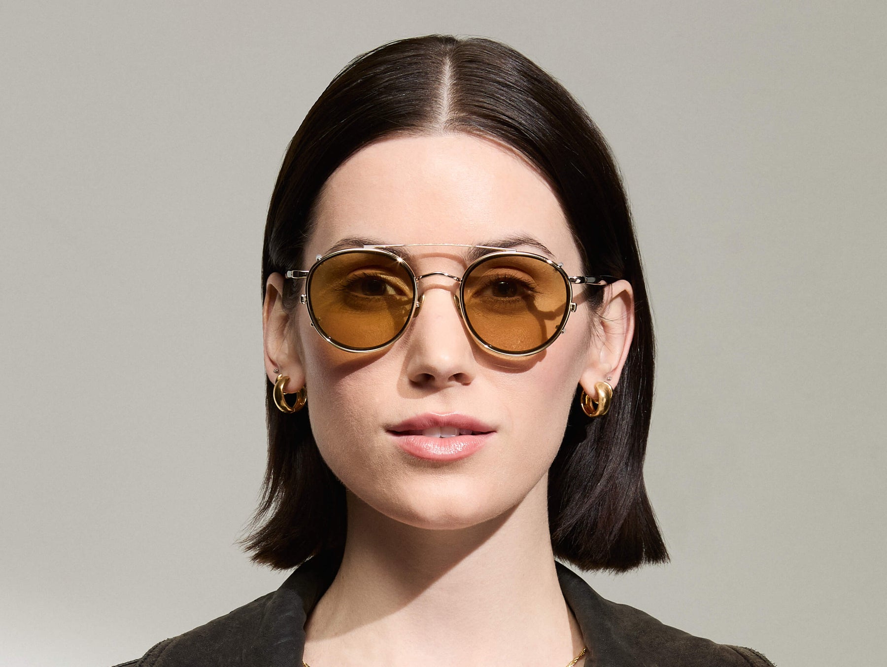 Model is wearing The ZEV CLIP in Gold in size 49 with Amber Tinted Lenses