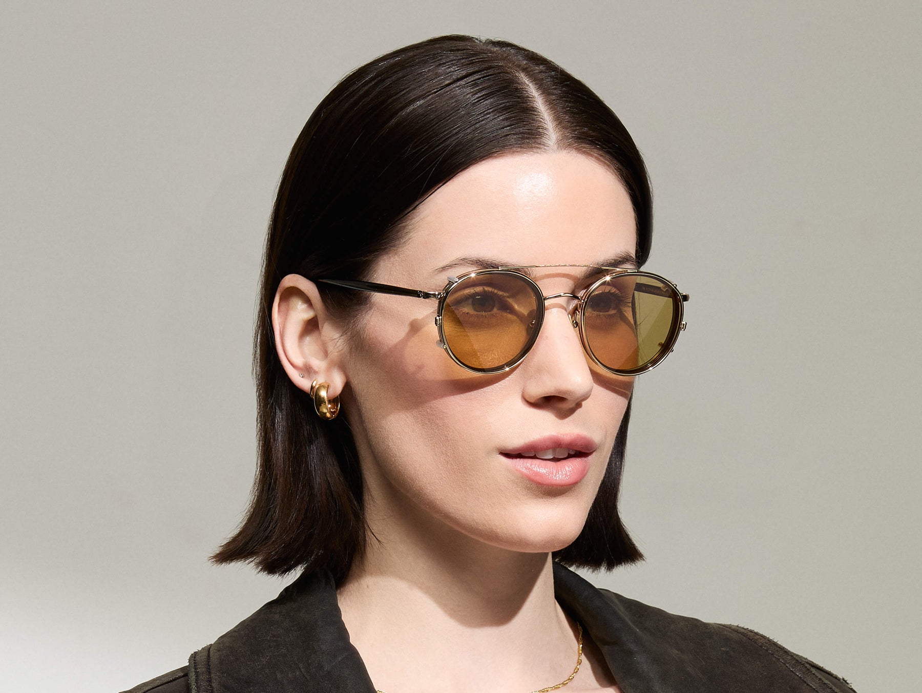 Model is wearing The ZEV CLIP in Gold in size 49 with Amber Tinted Lenses