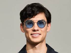 Model is wearing The ZEV CLIP in Gold in size 49 with Celebrity Blue Tinted Lenses