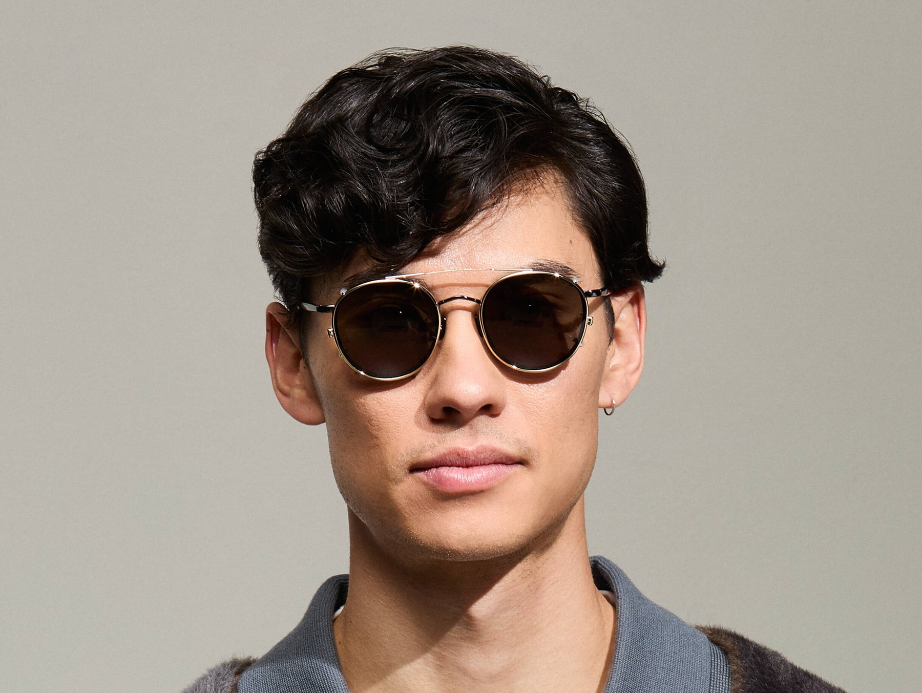 Model is wearing The ZEV CLIP in Gold in size 48 with G-15 Tinted Lenses