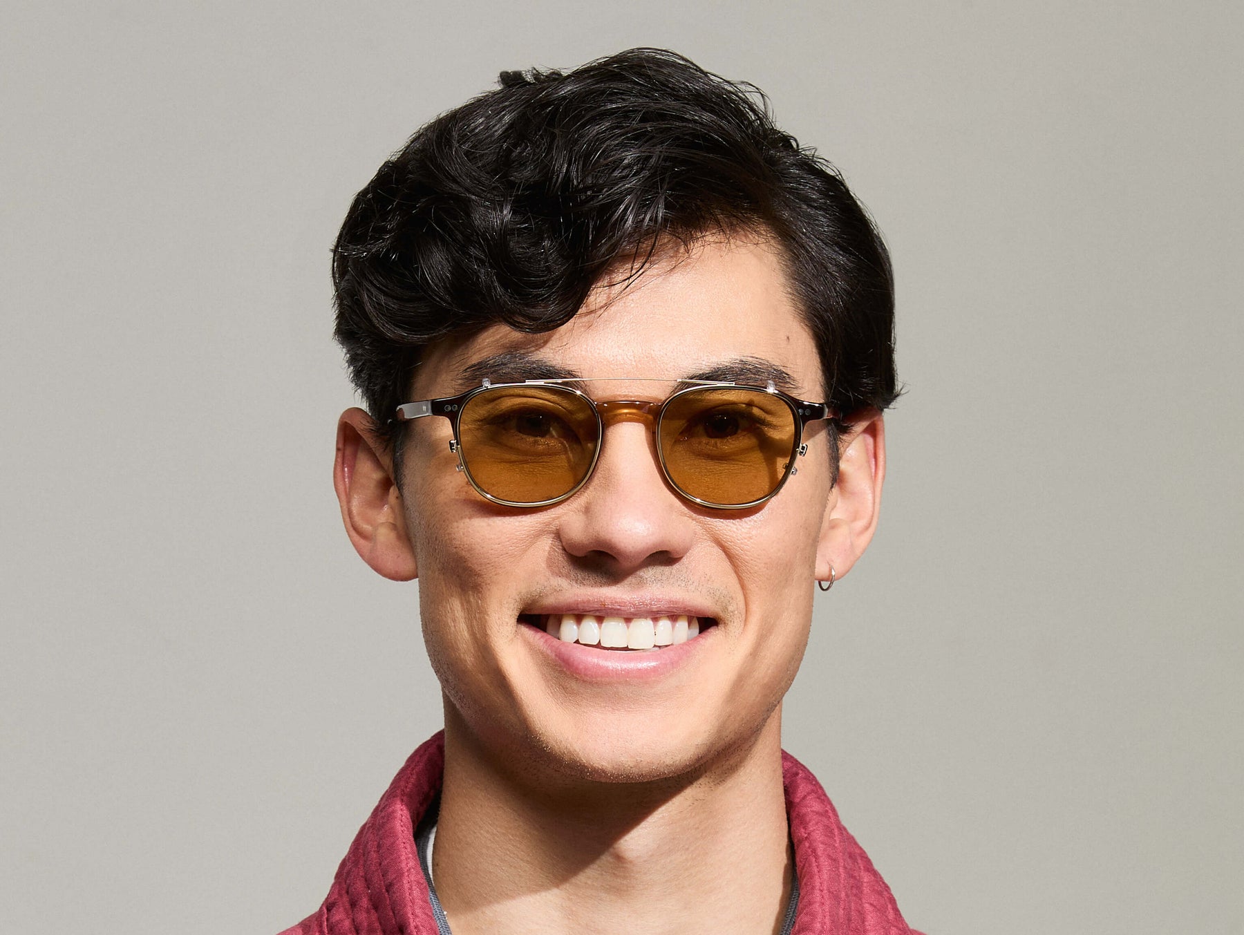 Model is wearing The ARTHUR CLIP in Gold in size 48 with Amber Tinted Lenses