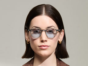 Model is wearing The ARTHUR CLIP in Gold in size 48 with Bel Air Blue Tinted Lenses