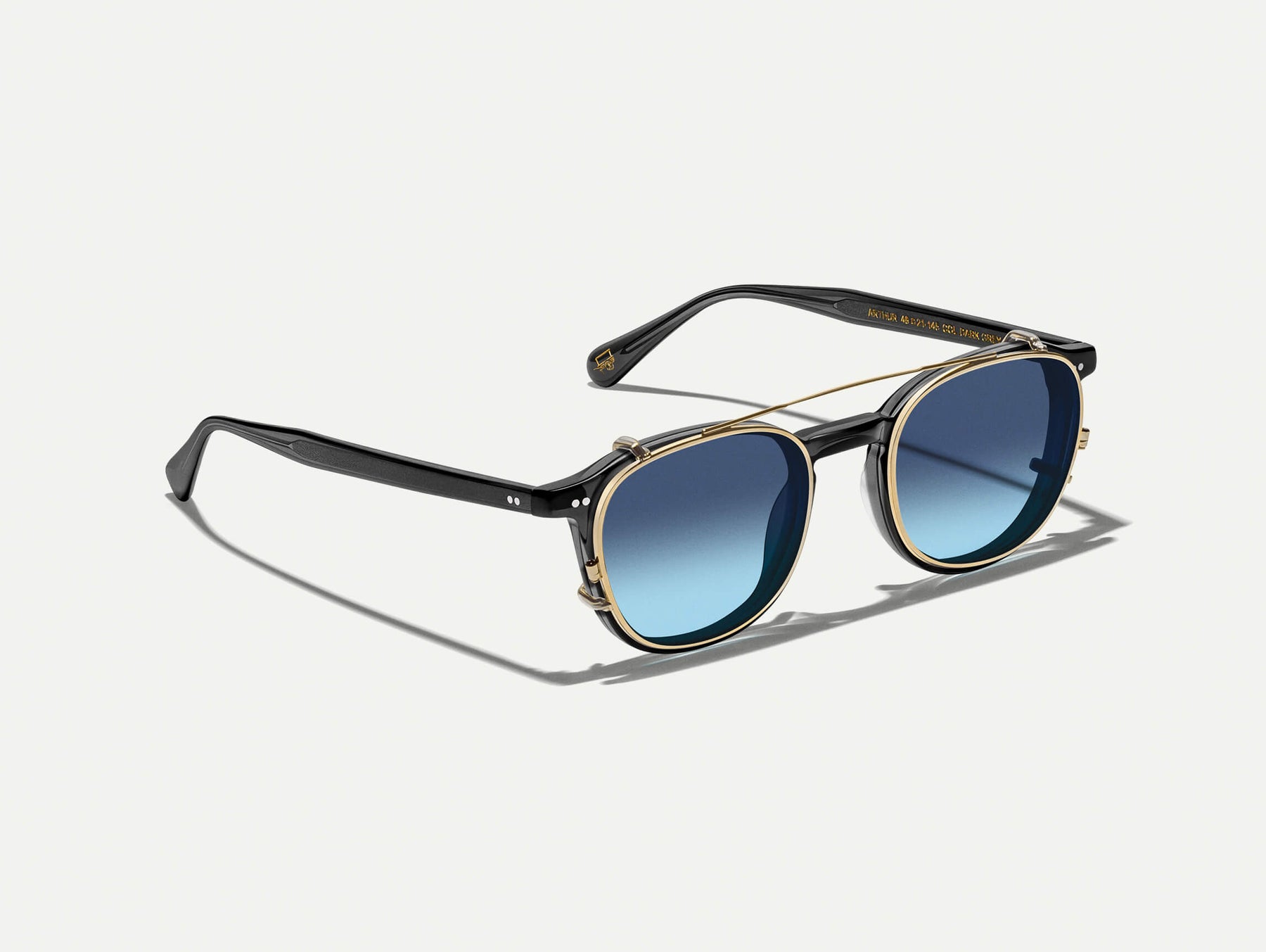 The ARTHUR CLIP  in Gold with Denim Blue Tinted Lenses