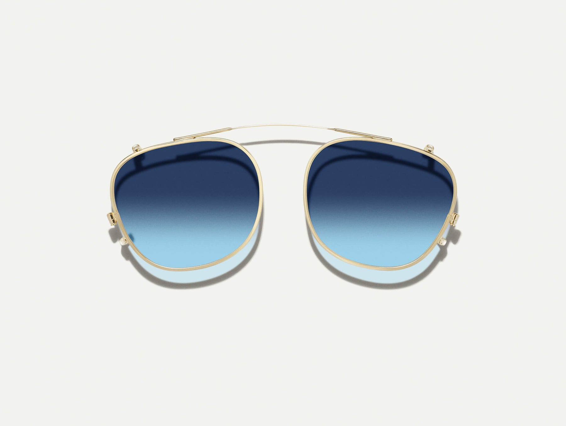 The ARTHUR CLIP  in Gold with Denim Blue Tinted Lenses