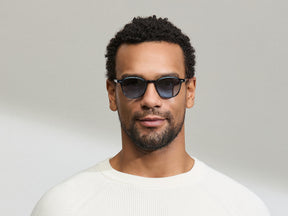 Model is wearing The ARTHUR in Ink in size 48 with Denim Blue Tinted Lenses