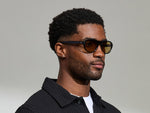 Model is wearing The AVRAM in size 54 in Black with Amber Tinted Lenses