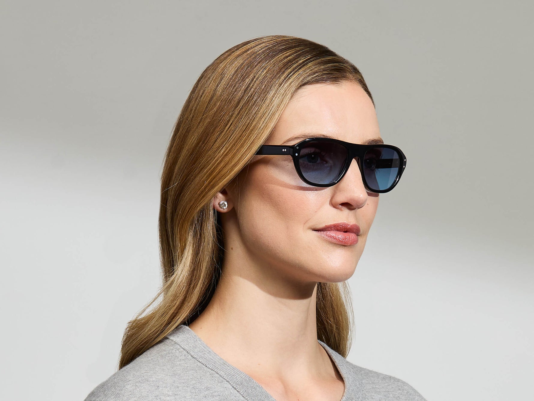 Model is wearing The AVRAM in size 54 in Black with Denim Blue Tinted Lenses
