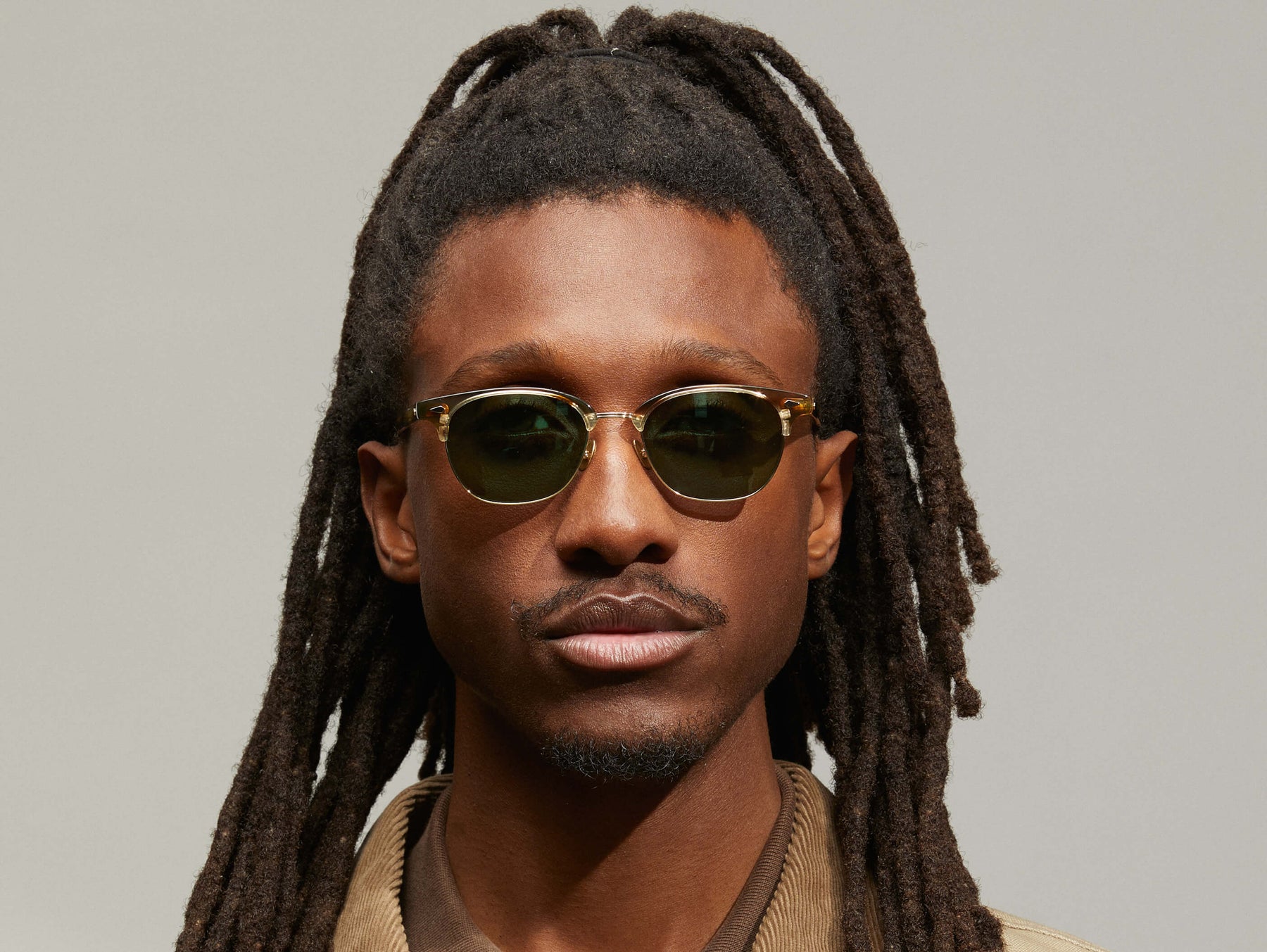 Model is wearing The AYGEN SUN in size 51 in Bamboo with G-15 Tinted Lenses