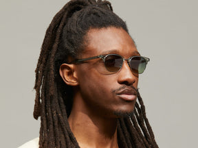 Model is wearing The AYGEN SUN in size 51 in Sage with Forest Wood Tinted Lenses