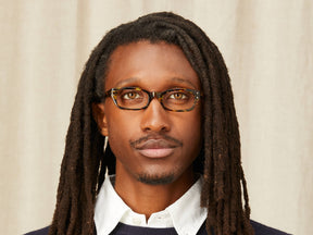 Model is wearing The BISSLE in size 48 in Amber Stripe