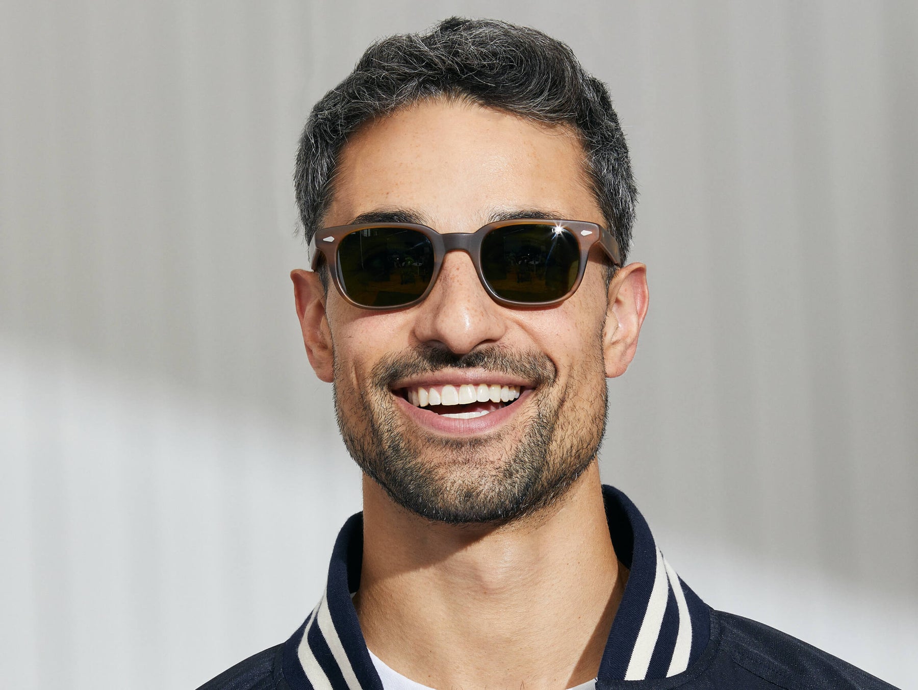 Model is wearing The BOYCHIK SUN in Matte Dark Blonde in size 49 with Calibar Green Glass Lenses