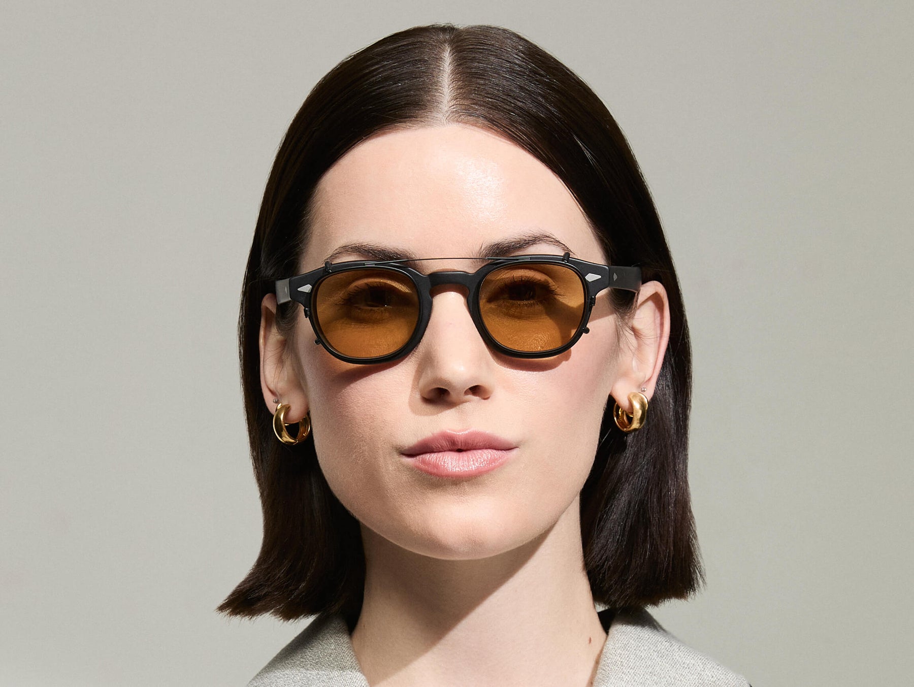 The Model is wearing The CLIPTOSH in Matte Black in size 46 with Amber Tinted Lenses