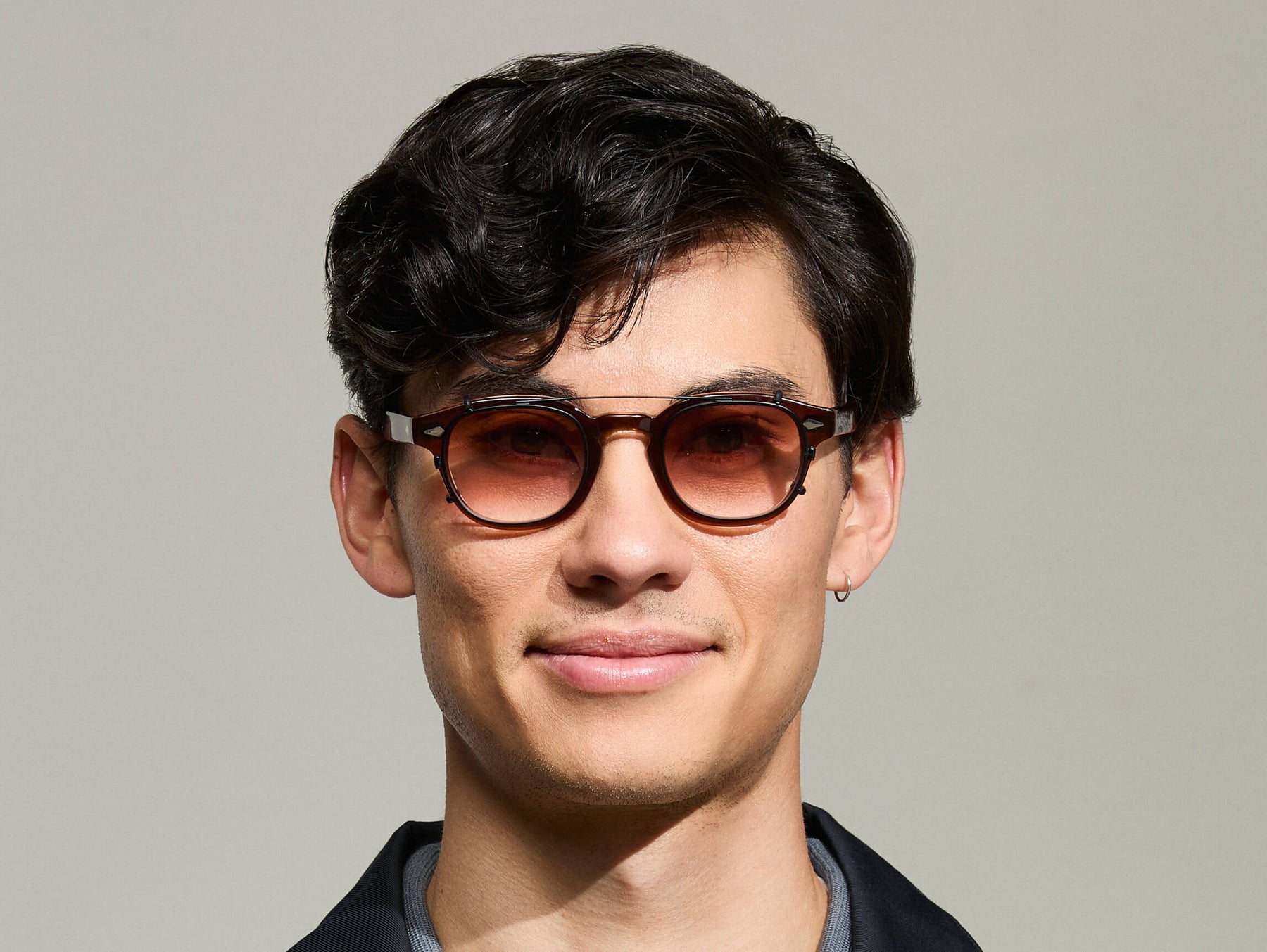 The Model is wearing The CLIPTOSH in Matte Black in size 46 with Root Beer Fade Tinted Lenses