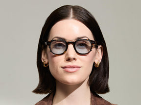 The Model is wearing The CLIPTOSH in Matte Black in size 46 with Bel Air Blue Tinted Lenses