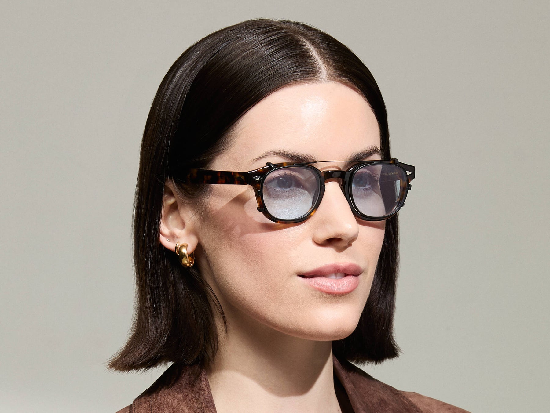 The Model is wearing The CLIPTOSH in Matte Black in size 46 with Bel Air Blue Tinted Lenses