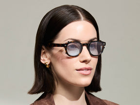The Model is wearing The CLIPTOSH in Matte Black in size 46 with Bel Air Blue Tinted Lenses