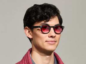 The Model is wearing The CLIPTOSH in Matte Black in size 46 with Big Apple Fade Tinted Lenses