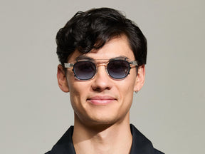 The Model is wearing The CLIPTOSH in Matte Black in size 46 with Denim Blue Tinted Lenses