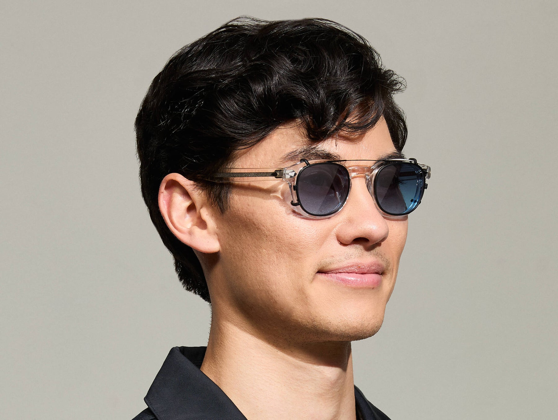 The Model is wearing The CLIPTOSH in Matte Black in size 46 with Denim Blue Tinted Lenses