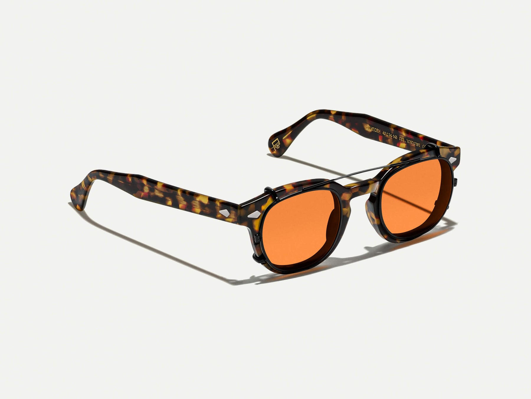 The CLIPTOSH in Matte Black with Woodstock Orange Tinted Lenses