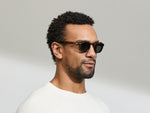 Model is wearing The CLIPTOSH in size 46 in Matte Black with G-15 Glass Polarized Lenses