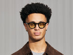 Model is wearing The DAHVEN in Black in size 47 with Limelight Tinted Lenses
