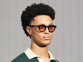 Model is wearing The DAHVEN in Black in size 47 with New York Rose Tinted Lenses