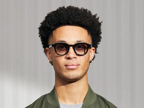 Model is wearing The DAHVEN in Black in size 47 with American Grey Fade Tinted Lenses