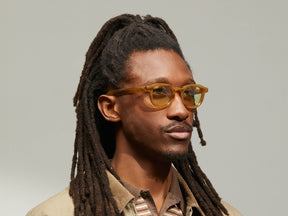 Model is wearing The DAHVEN in Blonde in size 44 with GREEN+ Tinted Lenses
