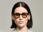 Model is wearing The DAHVEN in Tortoise in size 44 with Light Amber Tinted Lenses