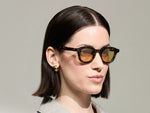 Model is wearing The DAHVEN in Tortoise in size 44 with Light Amber Tinted Lenses