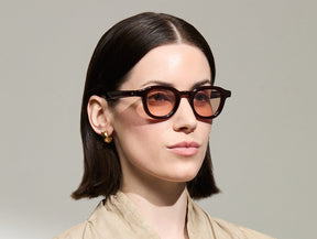 Model is wearing The DAHVEN in Burgundy in size 44 with New York Rose Tinted Lenses