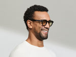 Model is wearing The DOLT in Navy in size 46 with AMBER+ Lenses