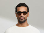 Model is wearing The DOLT in Navy in size 46 with AMBER+ Lenses