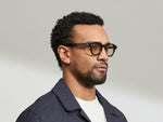 Model is wearing The DOLT in Dark Green in size 46 with AMBER+ Lenses