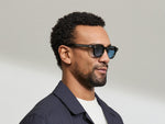 Model is wearing The DOLT in Dark Green in size 46 with BLUE+ Lenses