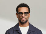 Model is wearing The DOLT in Grey-Brown Fade in size 46 with BLUE+ Lenses