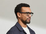 Model is wearing The DOLT in Grey-Brown Fade in size 46 with BLUE+ Lenses