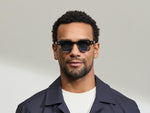 Model is wearing The DOLT in Grey-Brown Fade in size 46 with BLUE+ Lenses