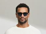 Model is wearing The DOLT in Navy in size 46 with BLUE+ Lenses