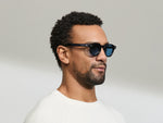 Model is wearing The DOLT in Navy in size 46 with BLUE+ Lenses