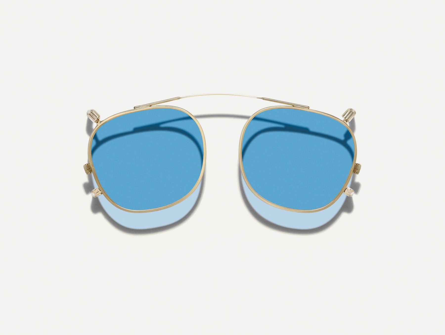 The DOLT CLIP in Gold with Celebrity Blue Tinted Lenses